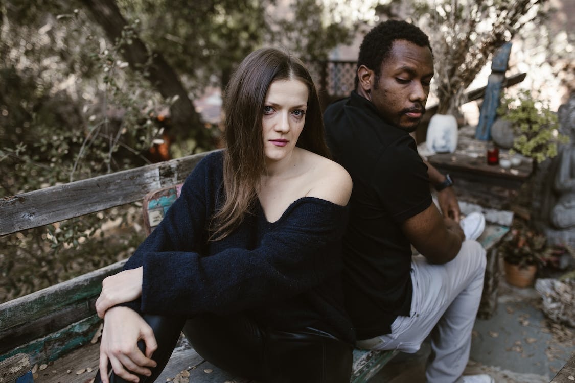Woman with weary eyes sitting with man